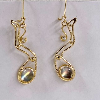 18k yellow gold earrings with Madagascar moonstones set in 22k gold with .09 ct. (TW) E color, VS clarity diamond accents. These moonstones need to be seen up close and personal as the photo does not do justice to the beautiful colors in these stones. 2 1/4 inches long and lightweight.