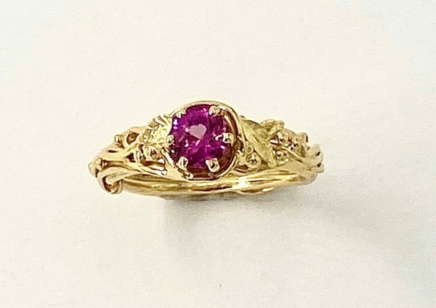 18k yellow gold leaf and vine design ring with a .74 ct. pink sapphire (H). This sapphire is particularly sparkly!