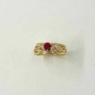 18k yellow gold ring with .53ct Burmese ruby set in platinum with two .03 ct. diamond accents, E color, VS clarity.
