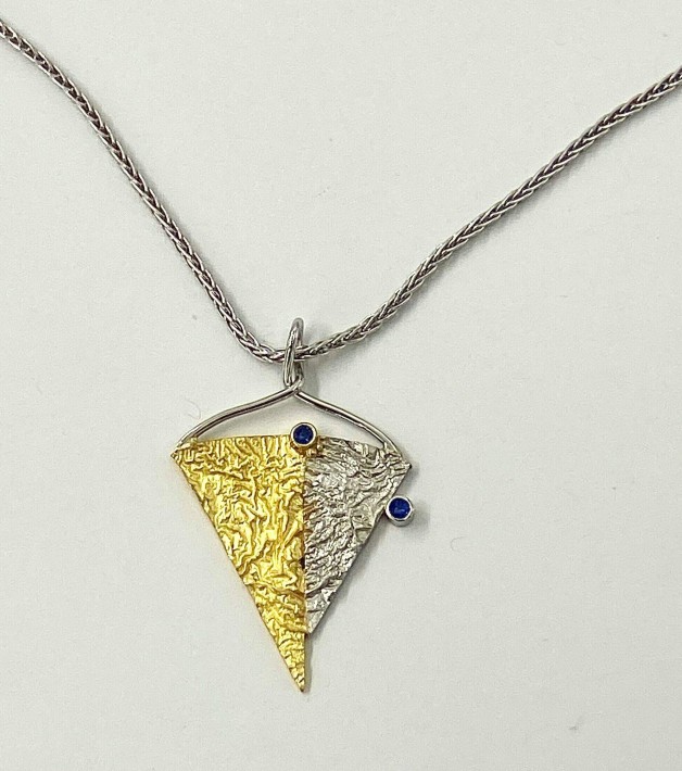 18k yellow gold and 950 platinum reticulated pendant with two blue sapphires (TW .13 cts.). Price includes a 16 - inch platinum chain.