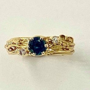 18k yellow gold ring with a .65 ct. Montana sapphire with two .03 ct., E color, VS clarity diamonds.