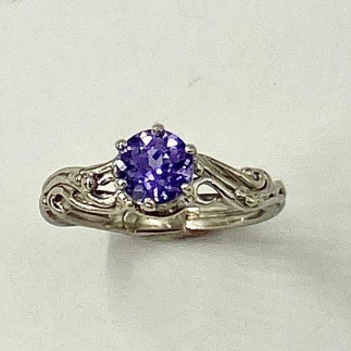950 platinum ring with a 1.31 ct. natural color, light purple sapphire set in a six prong setting with a swirling wire and bead design surrounding