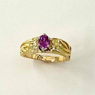 18k yellow gold ring with a .88 ct. (H) hot pink sapphire in a 6 prong platinum setting with floral designs on the sides.