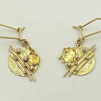 18k yellow gold earrings with .18 ct. (TW) E color, VS clarity diamonds with 22k plasma blasts. Earrings measures 1.5 inch in length.