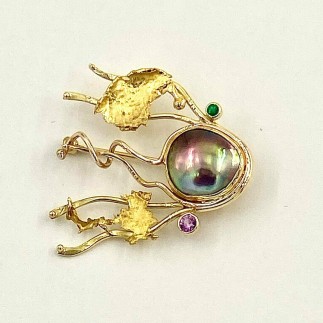 One of a kind comet pin in 18k yellow gold, 22k yellow gold and 14k red gold with a Sea of Cortez mabe pearl, a .05ct. emerald and a .17ct pink sapphire