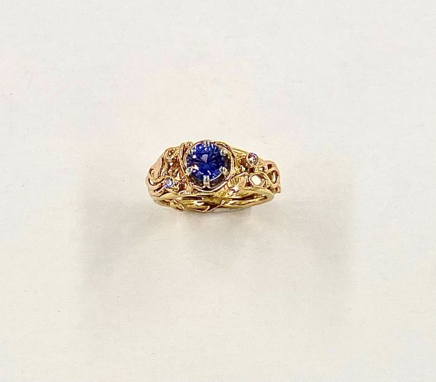 Custom hand built ring with purple sapphire and diamonds.