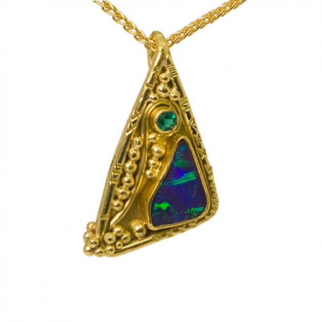 Jeweler Daniel Spirer of Boston created this 18k and 22k gold pendant with boulder opal and emeralds