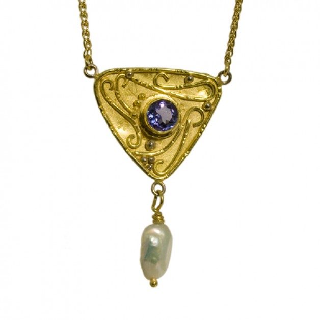 Cambridge, Massachusetts jeweler Daniel Spirer handcrafted this pendant with 18k yellow gold with tanzanite and freshwater pearl