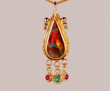 Boulder opal in 18k and 22k gold with rubies and emerald